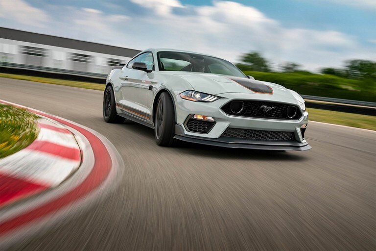 2023 Ford Mustang® Mach 1® driving on a closed course in iconic silver