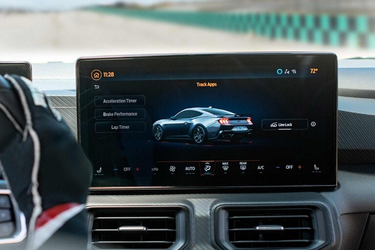 Interior view of a person driving a 2024 Ford Mustang® model on a closed course