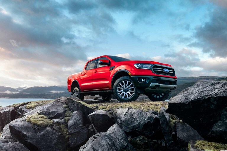2023 Ford Ranger SuperCrew® shown in Race Red being driven on rocky hill
