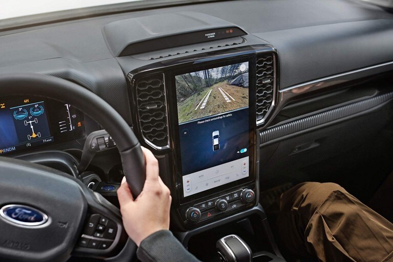 2024 Ford Ranger® center stack screen with two people engaged with the analog Rear View Camera