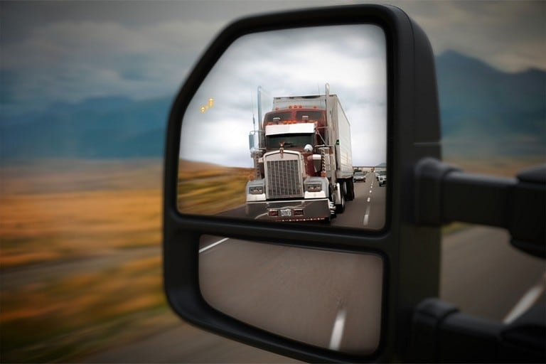 Side mirror of a Super Duty® LARIAT showing truck in blind spot with BLIS® enabled