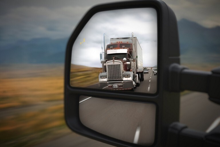 Side mirror of a Super Duty® LARIAT showing truck in blind spot with BLIS® enabled