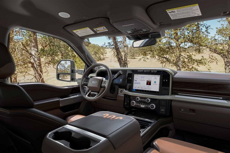 Front interior of a 2024 Ford Super Duty® King Ranch® pickup with Baja-colored leather seating surfaces