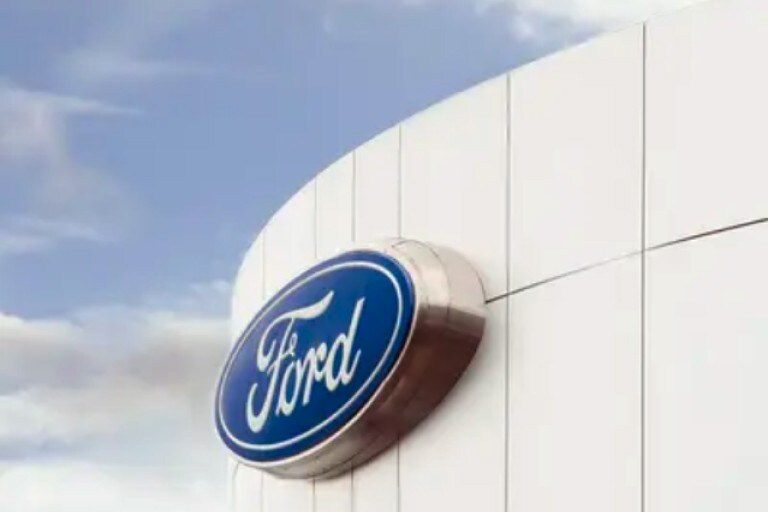 The Ford logo on the outside of a Ford dealership