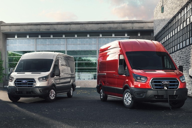 2 transit vans parked in front of building