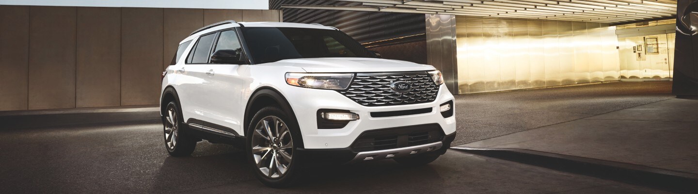 White Ford Explorer parked in an underground garage