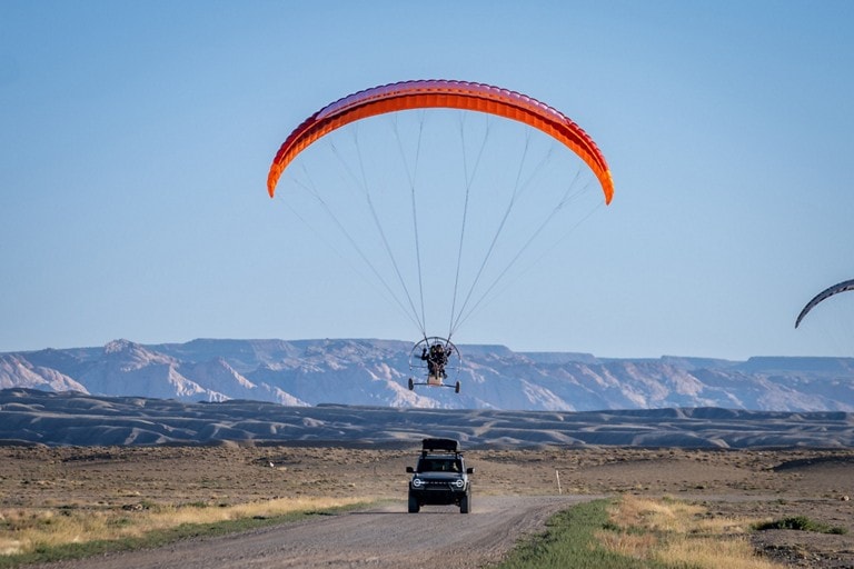 Bronco followed by paraglider