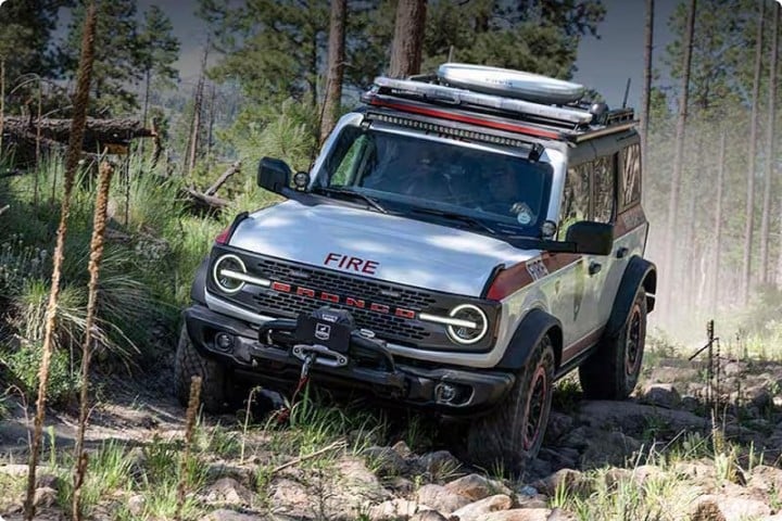 Bronco® Badlands® model with the Sasquatch® Off-Road Package being driven through a forest