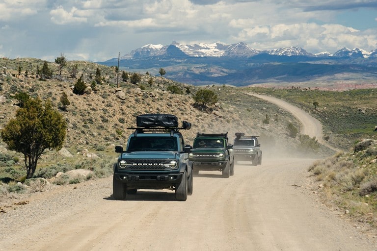 Bronco® Badlands® models being driven on a dirt road