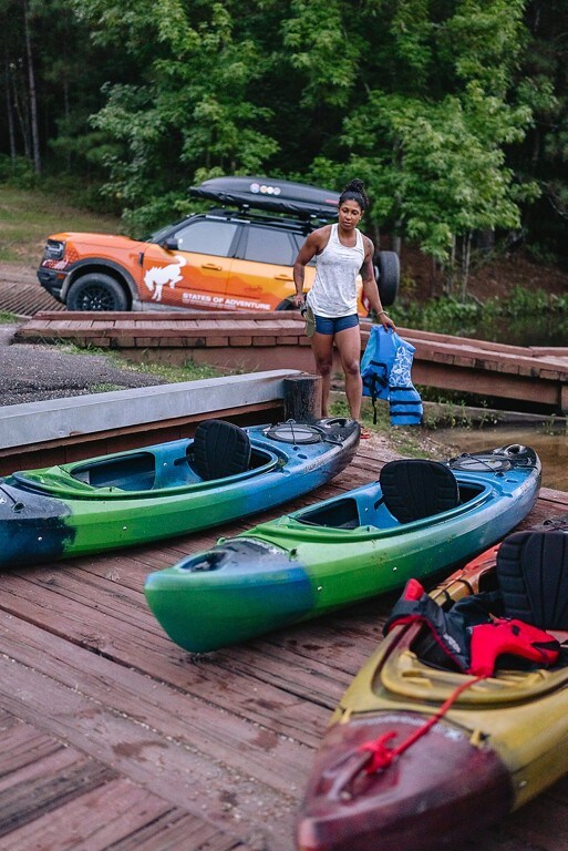 Preparing to kayak after unloading a Ford Bronco® Sport SUV.