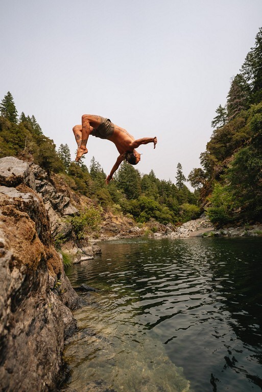 Man doing a backflip into the water at a state park