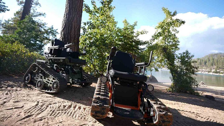 Two track chairs sitting near a beach