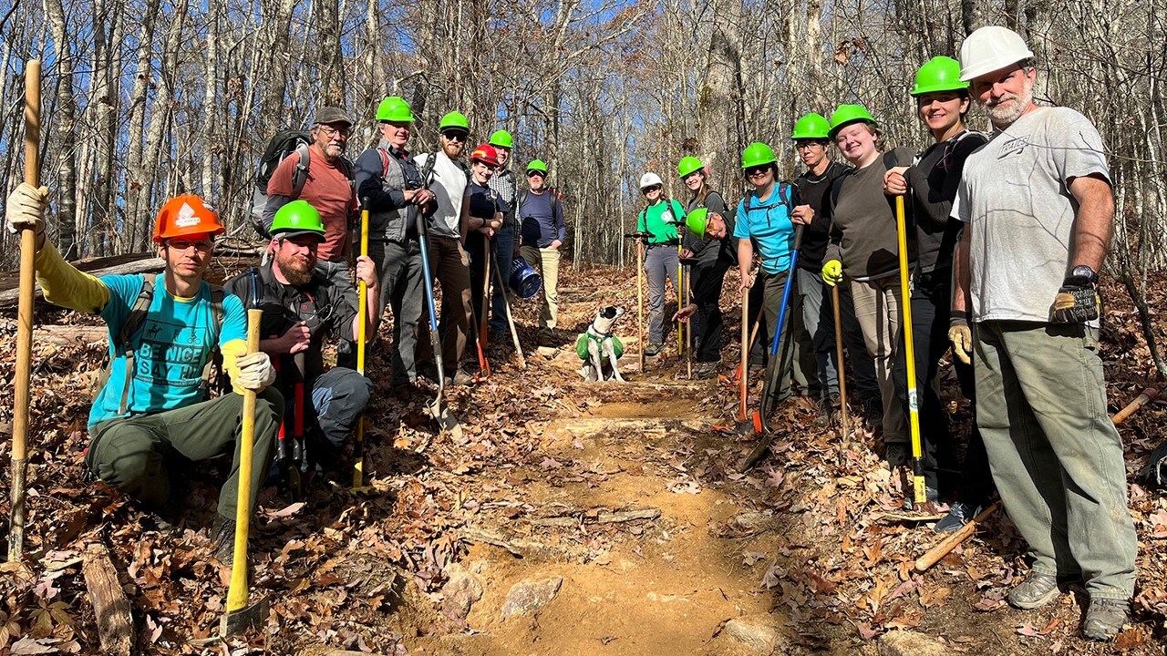 Volunteers lined up with hard hats on