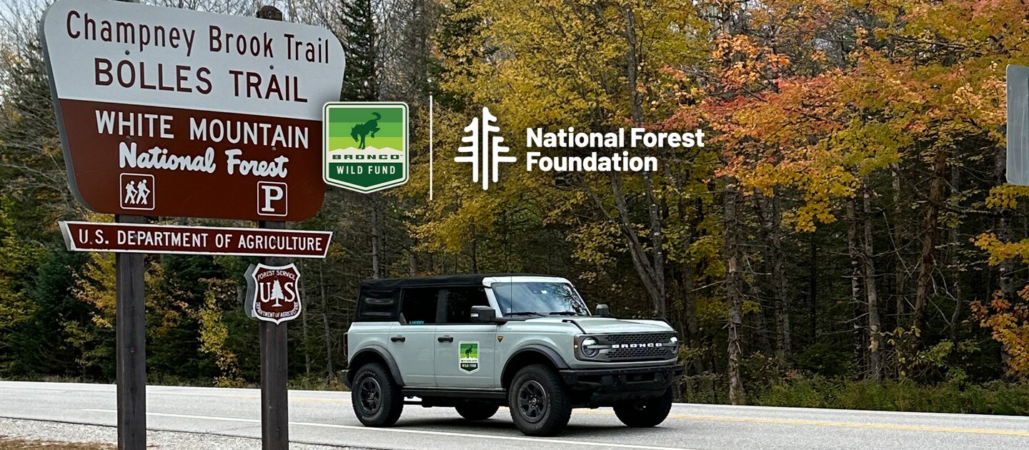 A Bronco® SUV approaching the White National Forest road sign.