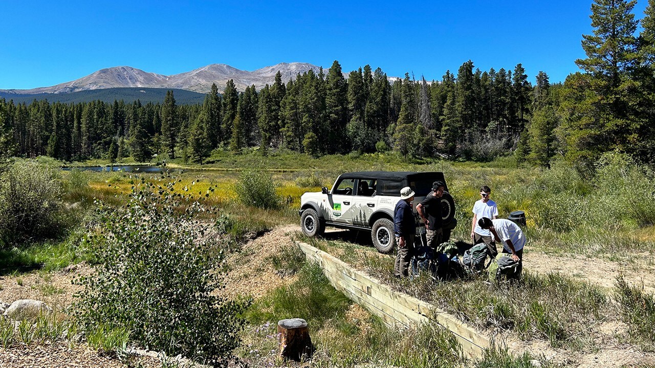 People gathering backpacking supplies.