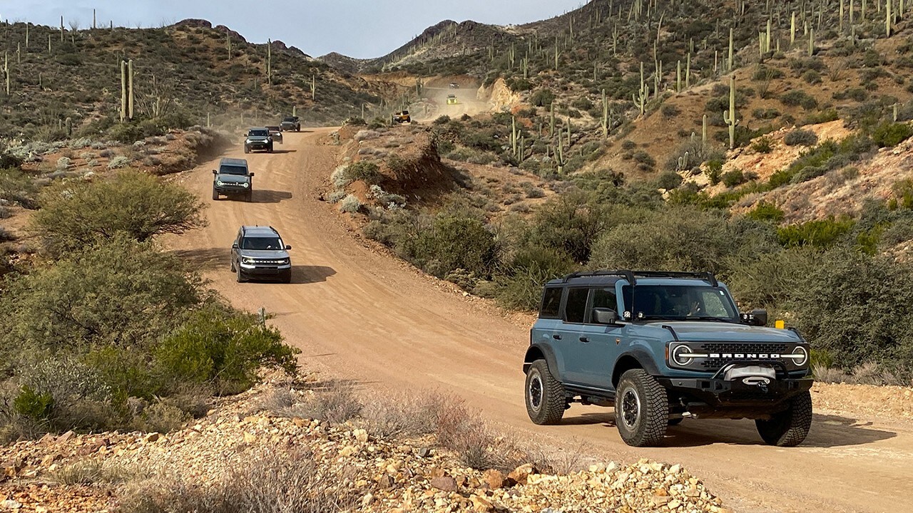 Bronco® and Bronco Sport SUVs being driven on a dirt road