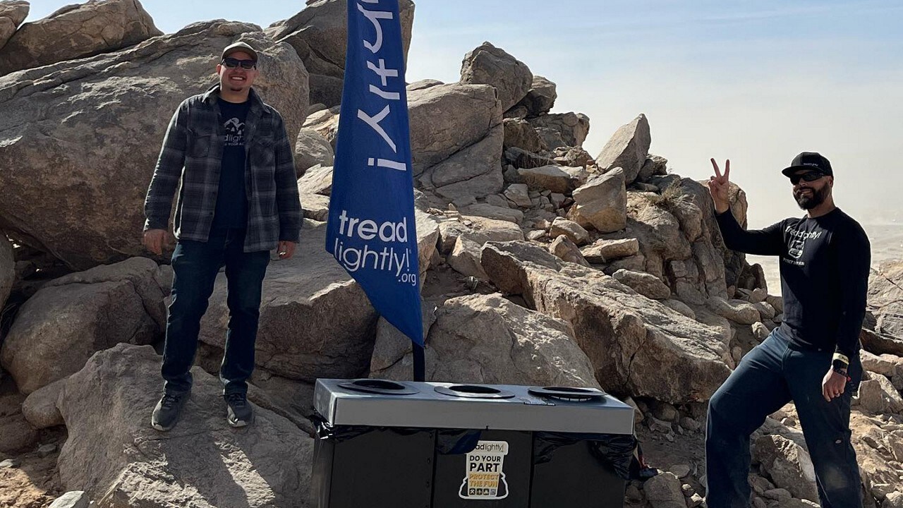 Two Tread Lightly! volunteers standing beside a pile of boulders