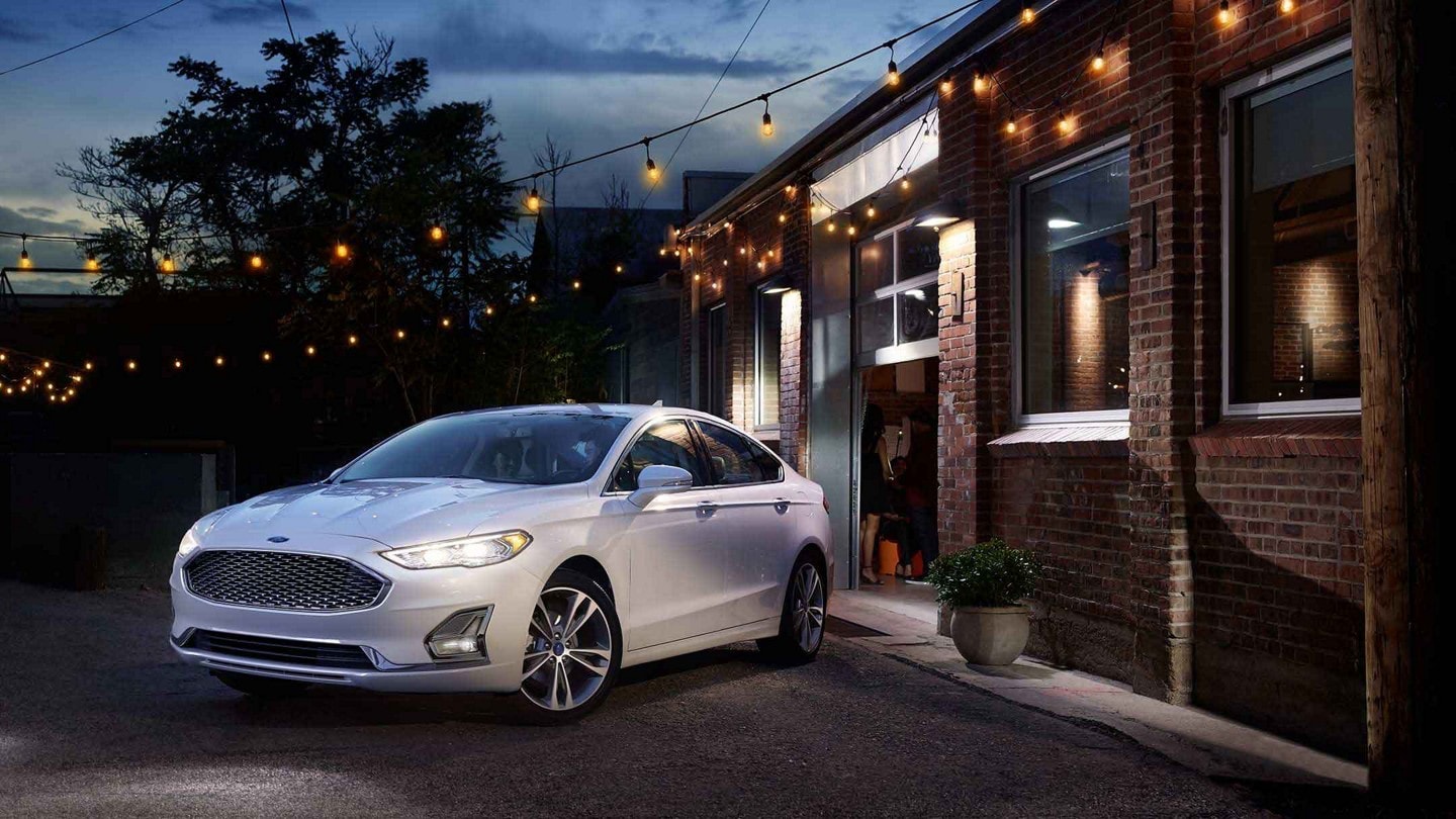 Ford Fusion in Oxford White parked near a building at night
