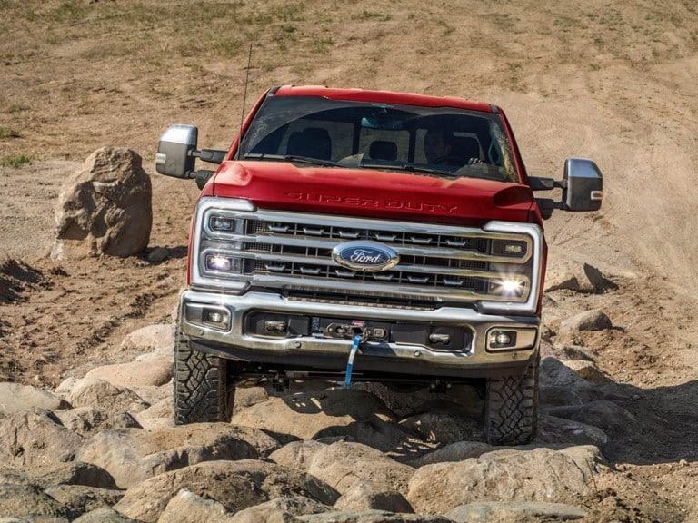 A Super Duty® truck being driven along a rocky off road path