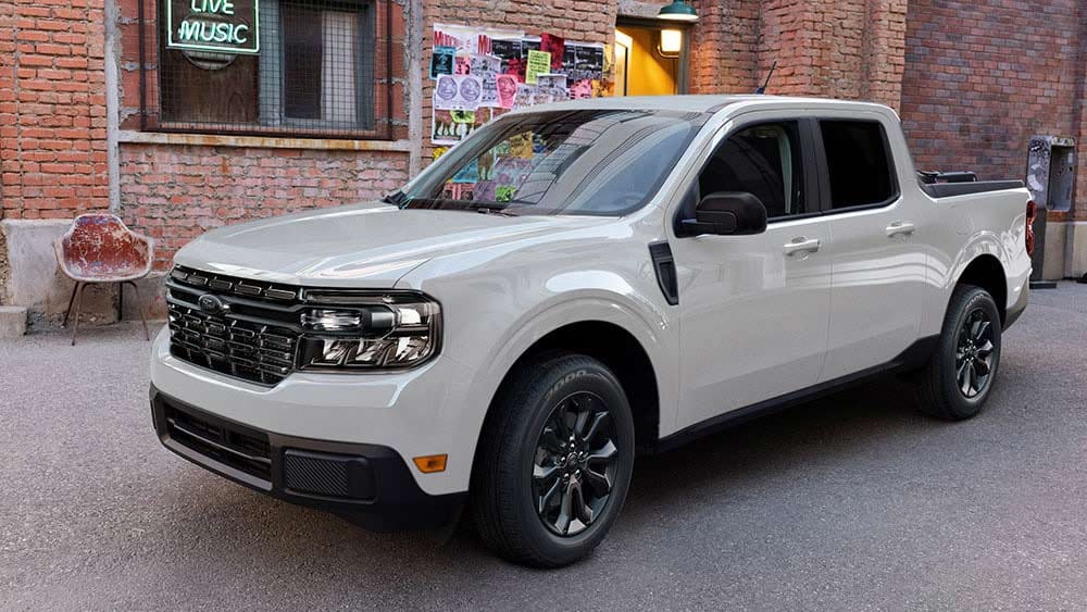 A Ford Maverick® parked in front of a small independent music store