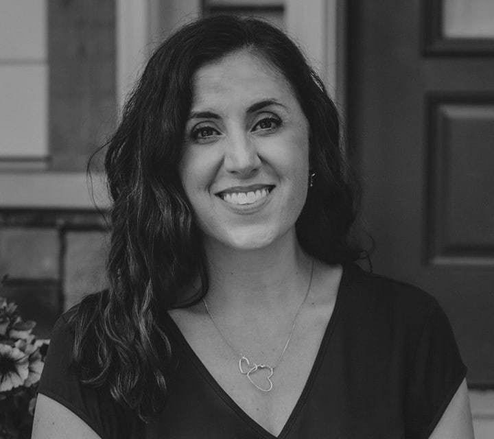 A close-up black and white portrait of Jennifer Brace, a woman innovator at Ford. Rollover of the photo enlarges her photo slightly. Clicking her photo takes you to her professional bio.