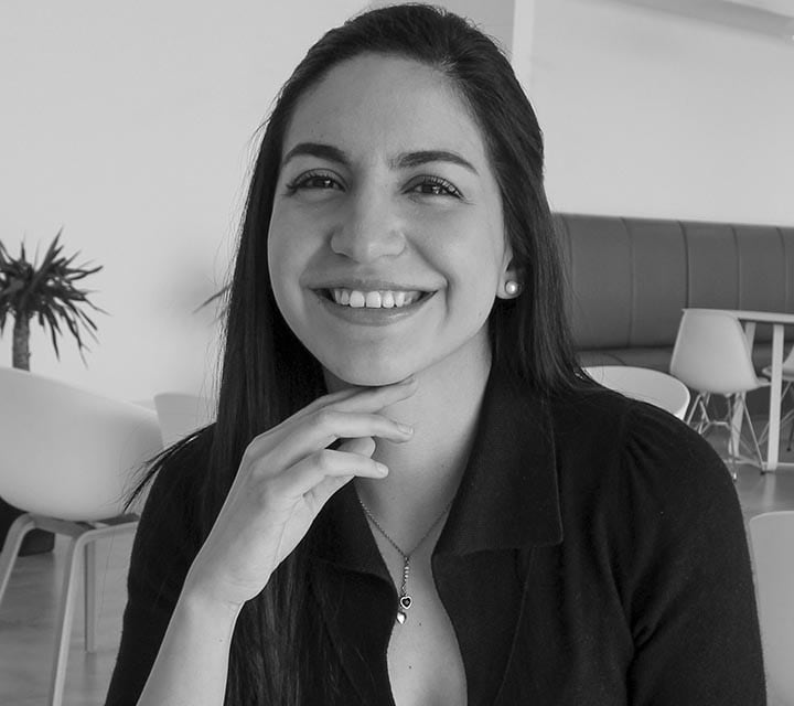 A close-up black and white portrait of Nicole Herrera, a woman innovator at Ford. Rollover of the photo enlarges her photo slightly. Clicking her photo takes you to her professional bio.