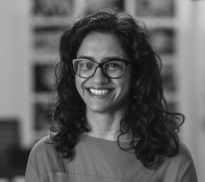 A close-up black and white portrait of Usha Raghavachari, a woman innovator at Ford. Rollover of the photo enlarges her photo slightly. Clicking her photo takes you to her professional bio.