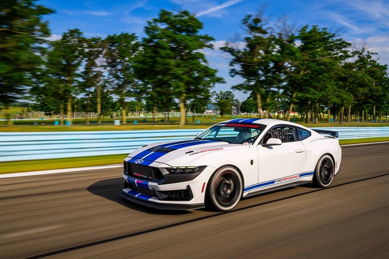 Ford Mustang® Dark Horse™ R race car being driven on a closed course