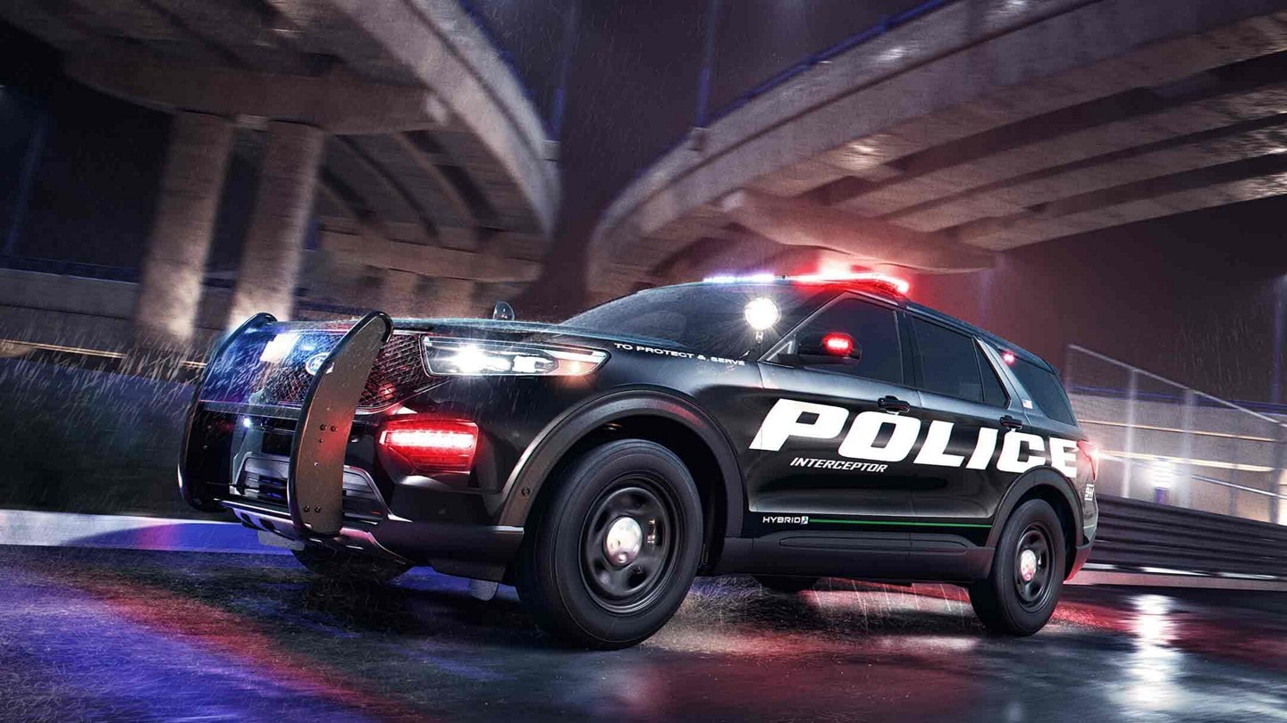 The ford police interceptor utility passing under a city bridge