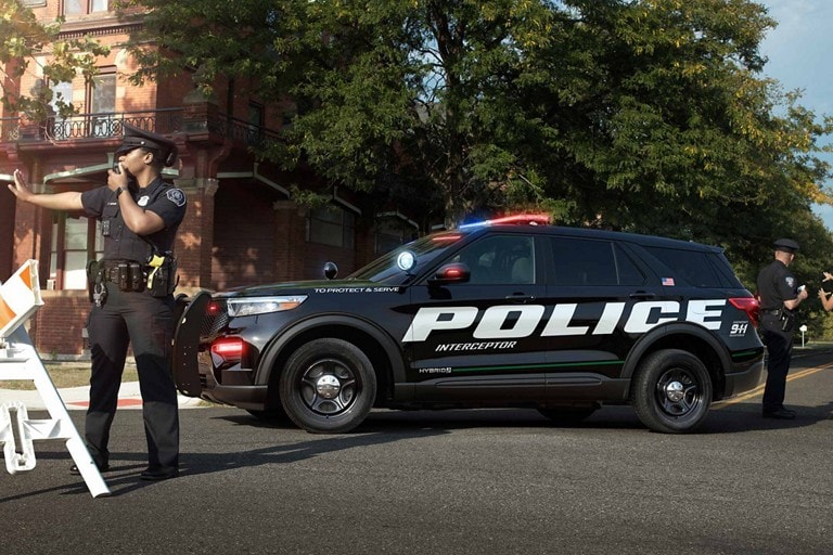 A ford police interceptor utility parked on a cordoned off street