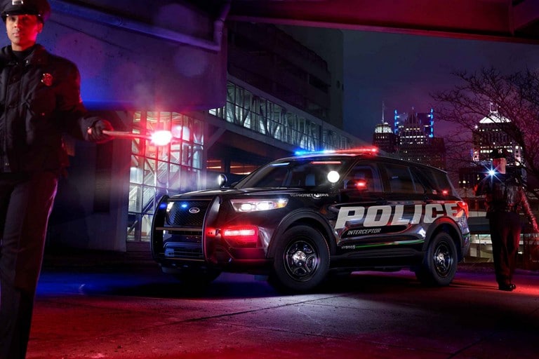 The ford police interceptor utility seen against a city skyline