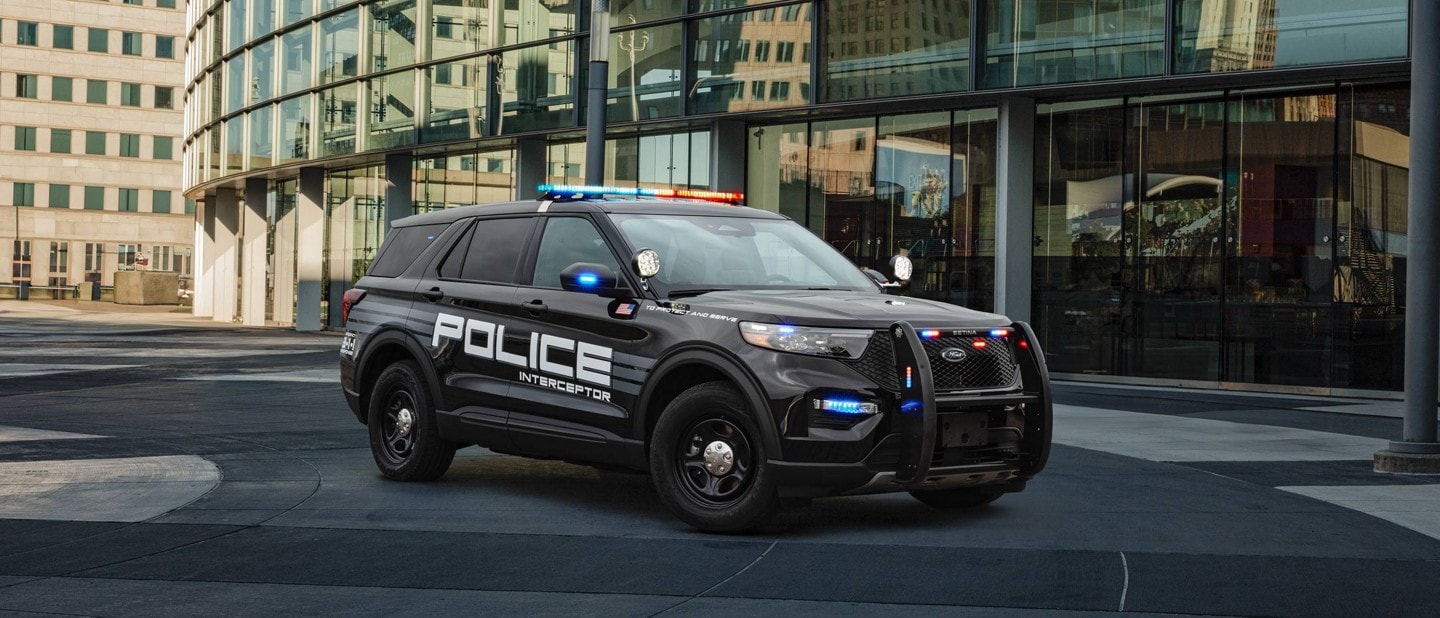 A 2025 Ford Police Interceptor® Utility parked next to an urban building