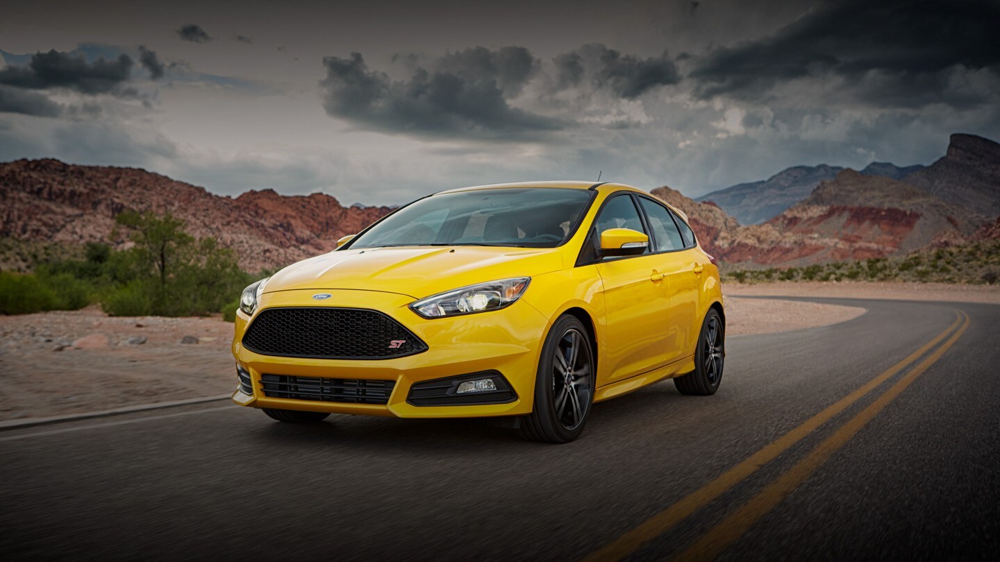 A yellow 2018 Ford Focus® being driven down an open highway