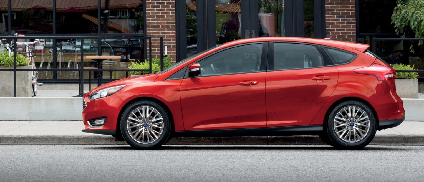 A red 2018 Ford Focus® parked in front of an office building
