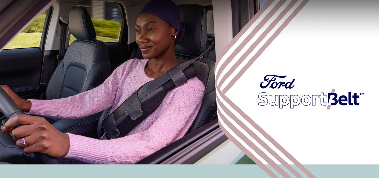 Woman driving a Ford vehicle is wearing a Ford SupportBelt seat belt accessory made for mastectomy patients.