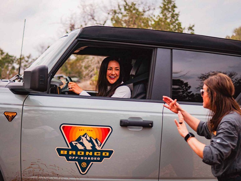 A grey Ford Bronco® SUV with a new owner learning behind the wheel at a  Bronco Off-Roadeo® event
