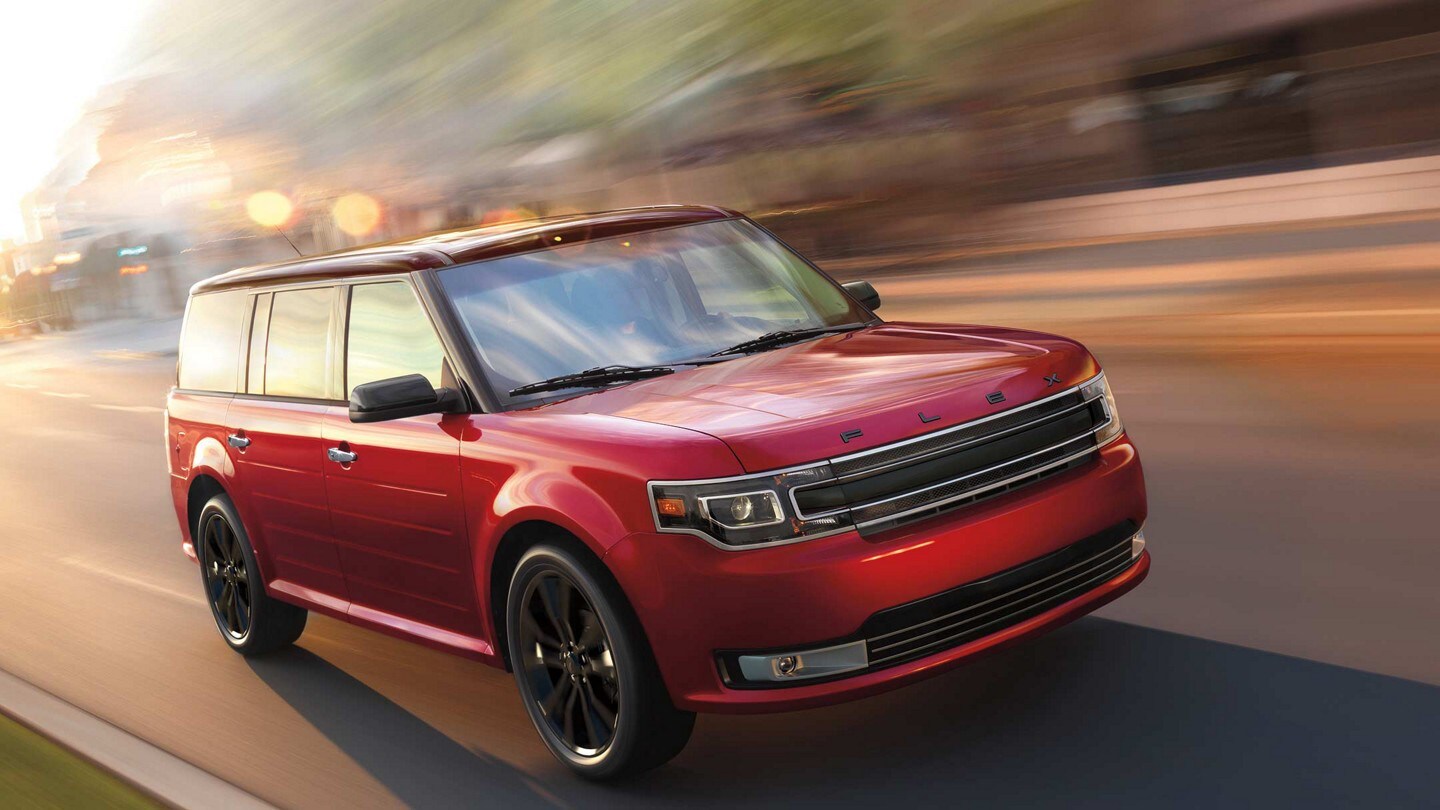Ford Flex Limited in Ruby Red Metallic Tinted Clearcoat being driven through the city