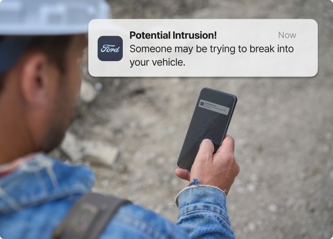 Man looking at his phone at construction site.