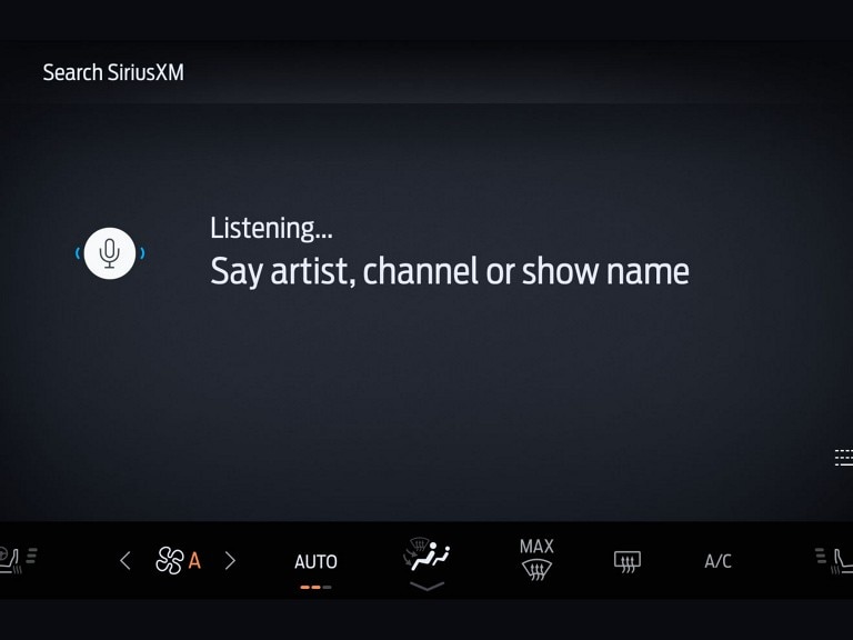 SiriusXM black in-vehicle technology screen with voice search prompt displayed.