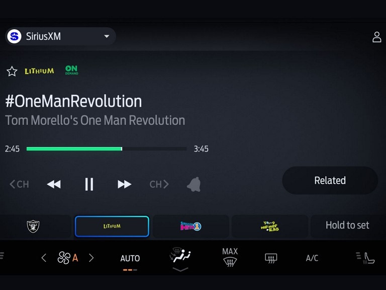 SiriusXM black in-vehicle technology screen with musical artist information displayed.