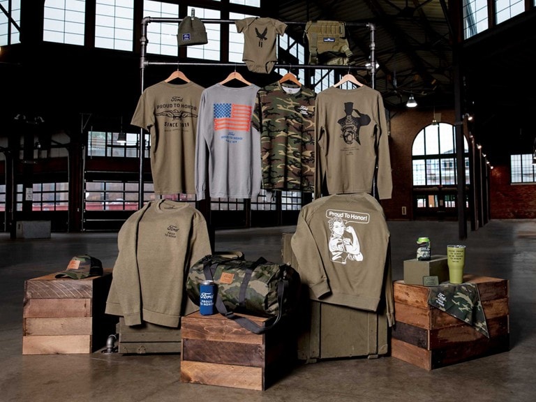 An assortment of Ford merchandise displayed in a dramatically lit industrial warehouse