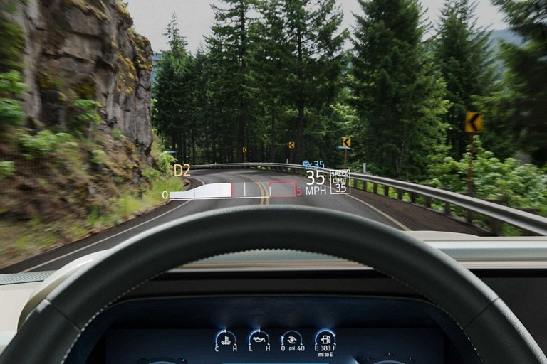 Driver perspective showing the head-up display projected onto the windshield