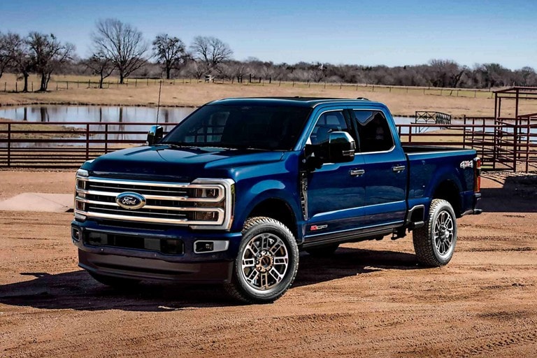 2025 Ford Super Duty® pickup in Atlas Blue parked at a farm