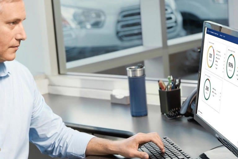 A man viewing Ford Telematics™ info using a desktop computer