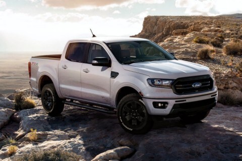 2020 Ford Ranger LARIAT in White Platinum with Black Appearance Package parked on top of cliff at sunrise