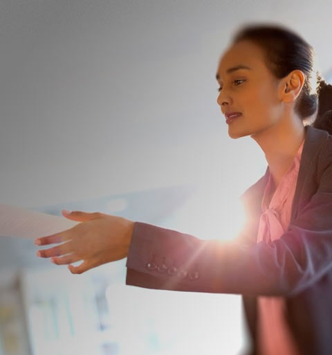 Woman using left hand to pass paper