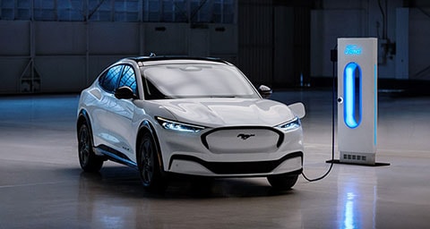 2021 Mustang Mach-E plugged into a charging station in a large garage