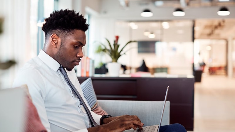 A business man typing on his laptop