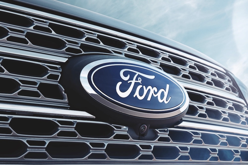 Ford logo on a vehicle grille, symbolizing Ford’s legacy in the automotive industry