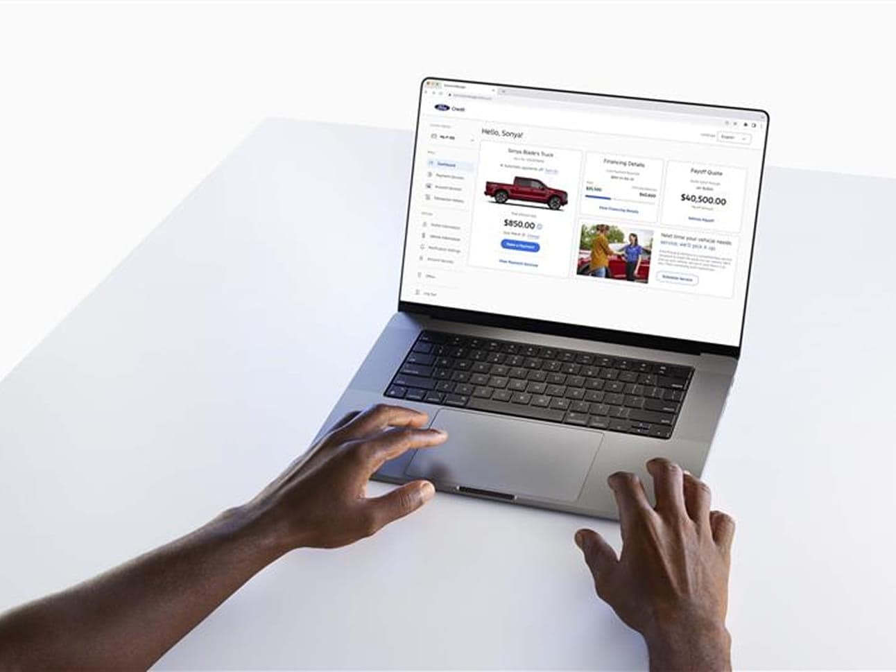 A person using Ford Credit Account Manager on their laptop computer.